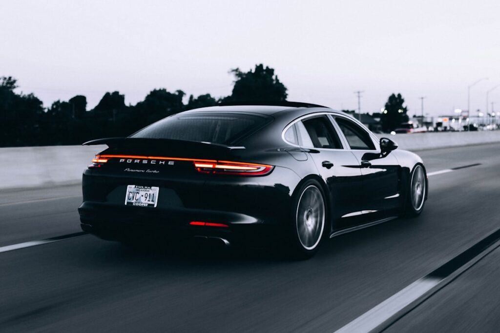 Luxury sedan with V-KOOL tinted windows on the road